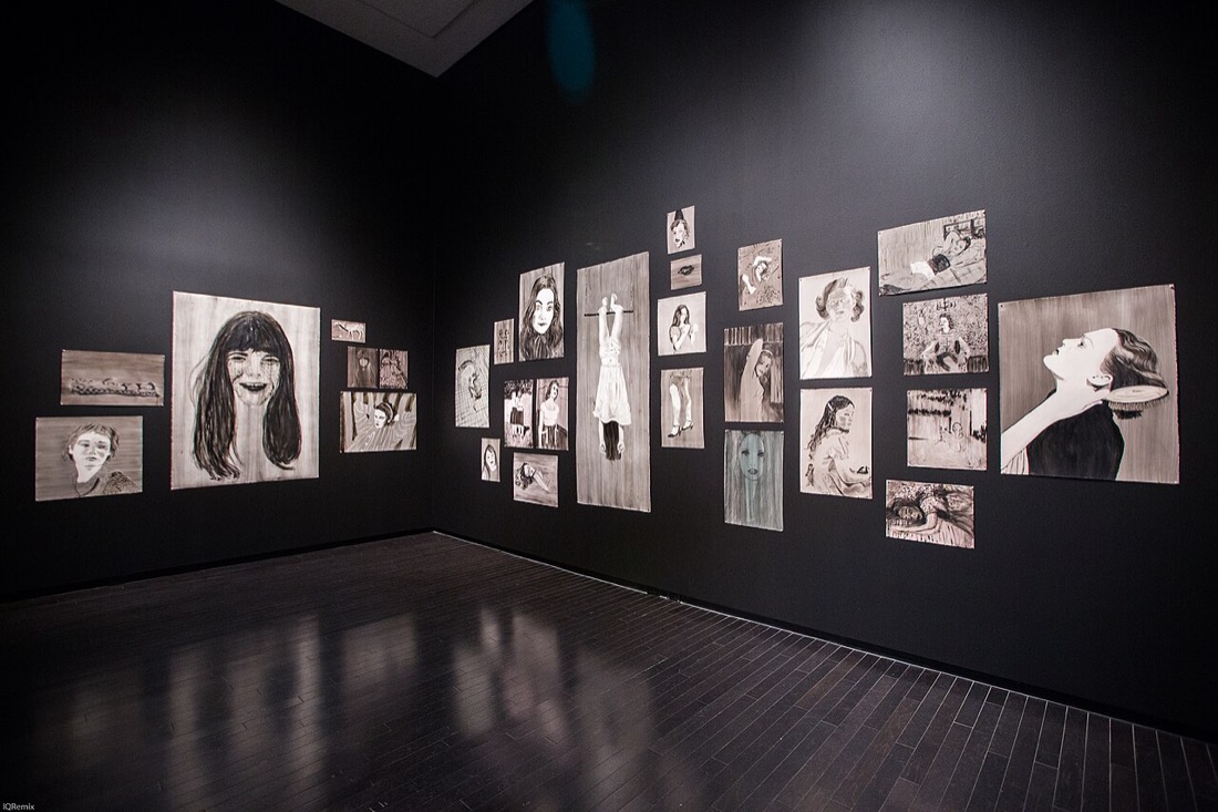 The interior of an art gallery with works on the walls