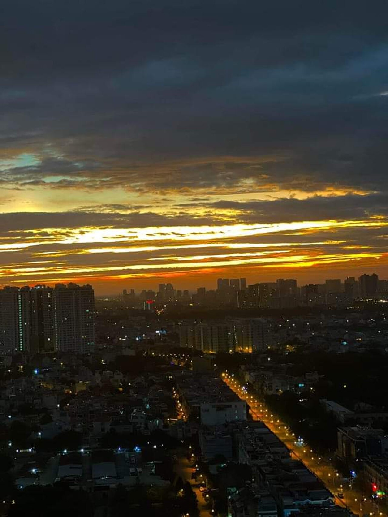 A rooftop bar overlooking the Bangkok skyline at dusk